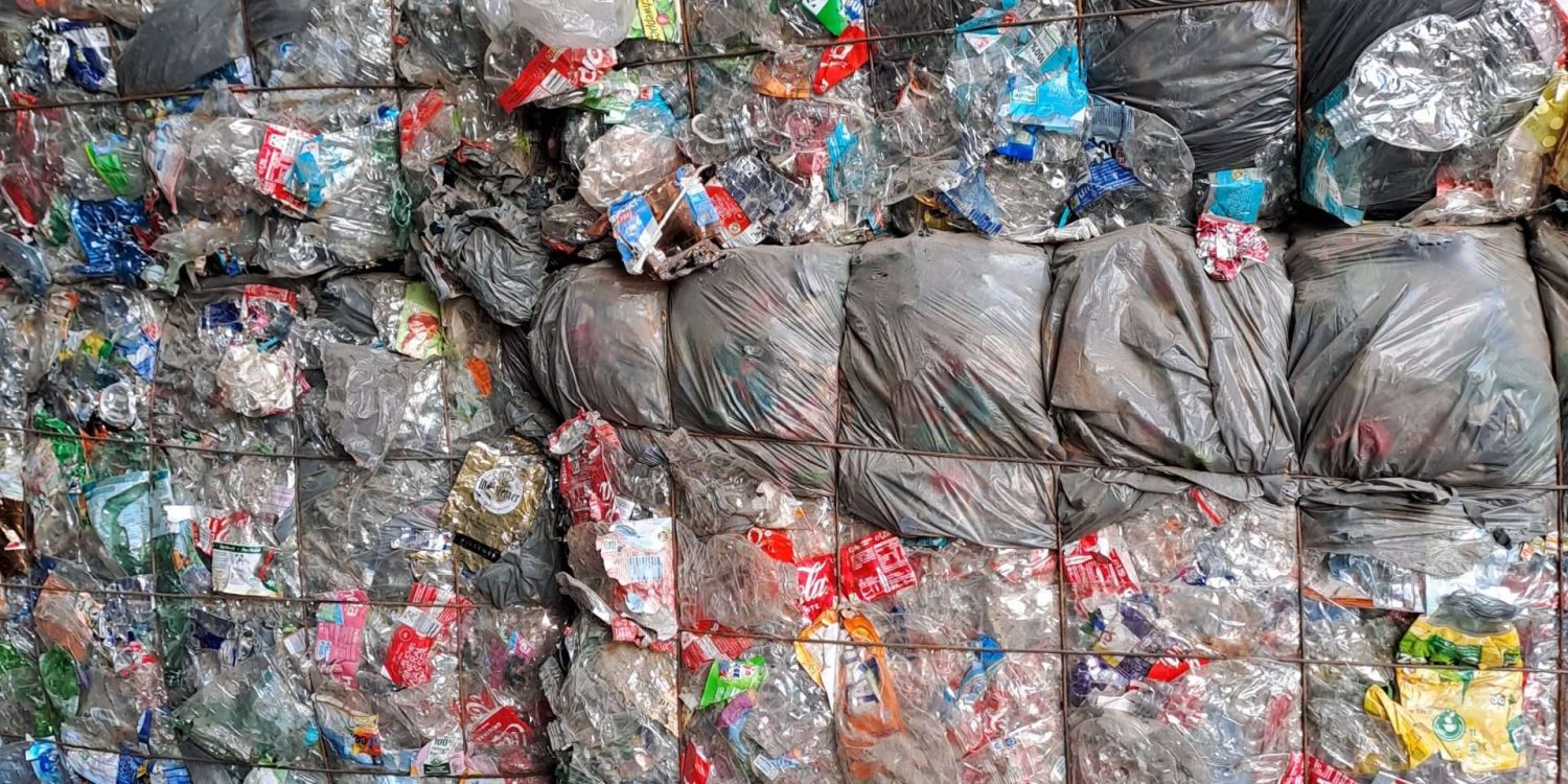 Plastikflaschen und Dosen verpresst Zu Bündeln gepresste und aufgestapelte alte Plastikflaschen und Getränkedosen, Foto: EMO